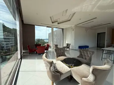 Luxurious modern living room with elegant furniture and panoramic windows offering stunning views.