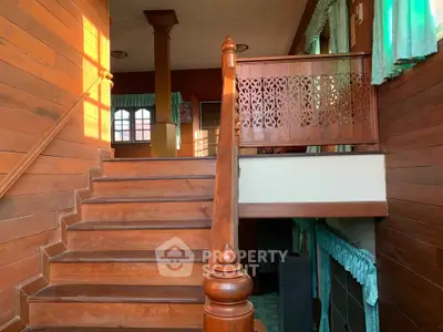 Charming wooden staircase with intricate railing in a cozy home interior