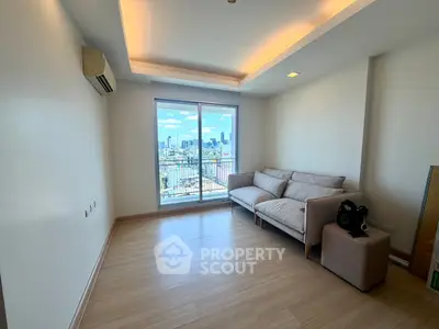 Spacious living room with city view and modern sofa in high-rise apartment