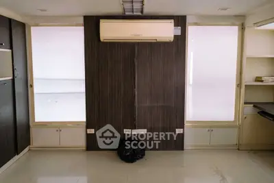 Modern interior space with air conditioning and sleek cabinetry, ideal for versatile use.