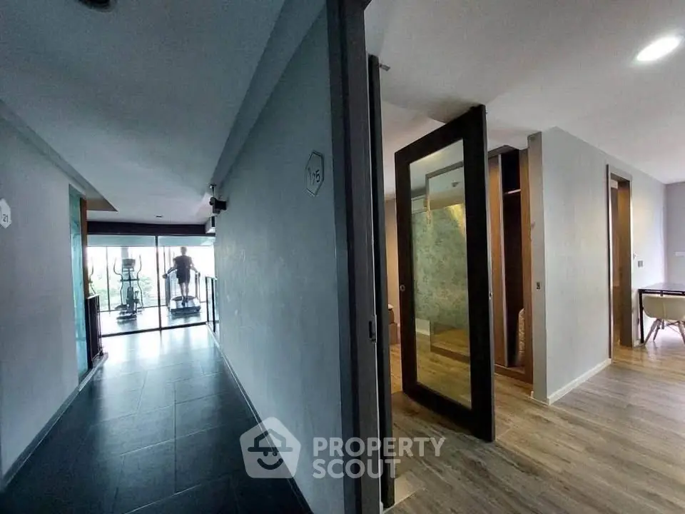 Modern apartment hallway with gym access and stylish interior design