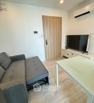 Modern living room with sleek furniture and air conditioning, perfect for comfortable urban living.