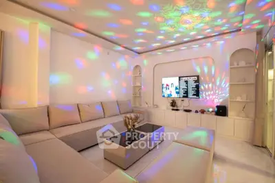 Luxurious living room with modern lighting and spacious seating area, perfect for entertainment.