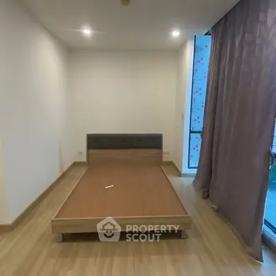 Spacious bedroom with modern design and large window for natural light