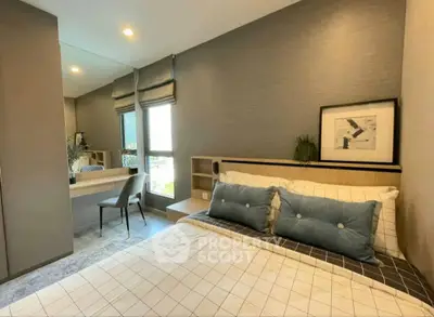 Modern bedroom with stylish decor and large window offering natural light.