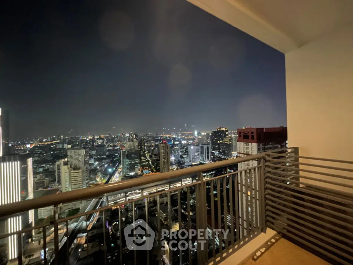 Stunning cityscape view from a high-rise balcony at night, perfect for urban living.