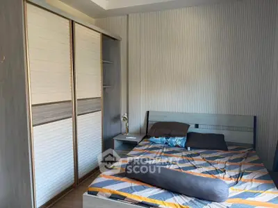 Cozy bedroom with modern design and ample storage space, perfect for relaxation and comfort.