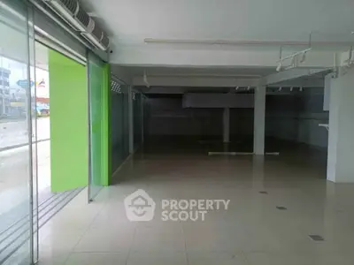 Spacious commercial property with large windows and open floor plan, ideal for retail or office space.