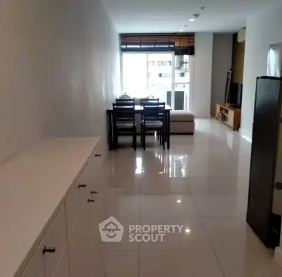 Spacious living room with modern furniture and large windows offering natural light.