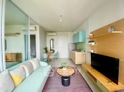 Modern living room with stylish decor and open kitchen layout in a cozy apartment.