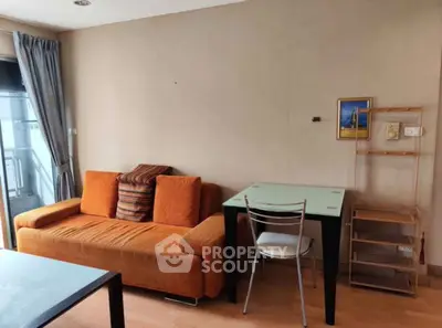 Cozy living room with orange sofa and modern furniture in a bright apartment.