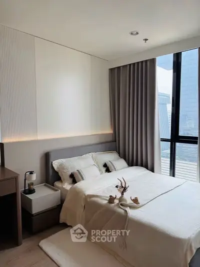 Modern bedroom with large window and elegant decor in urban apartment