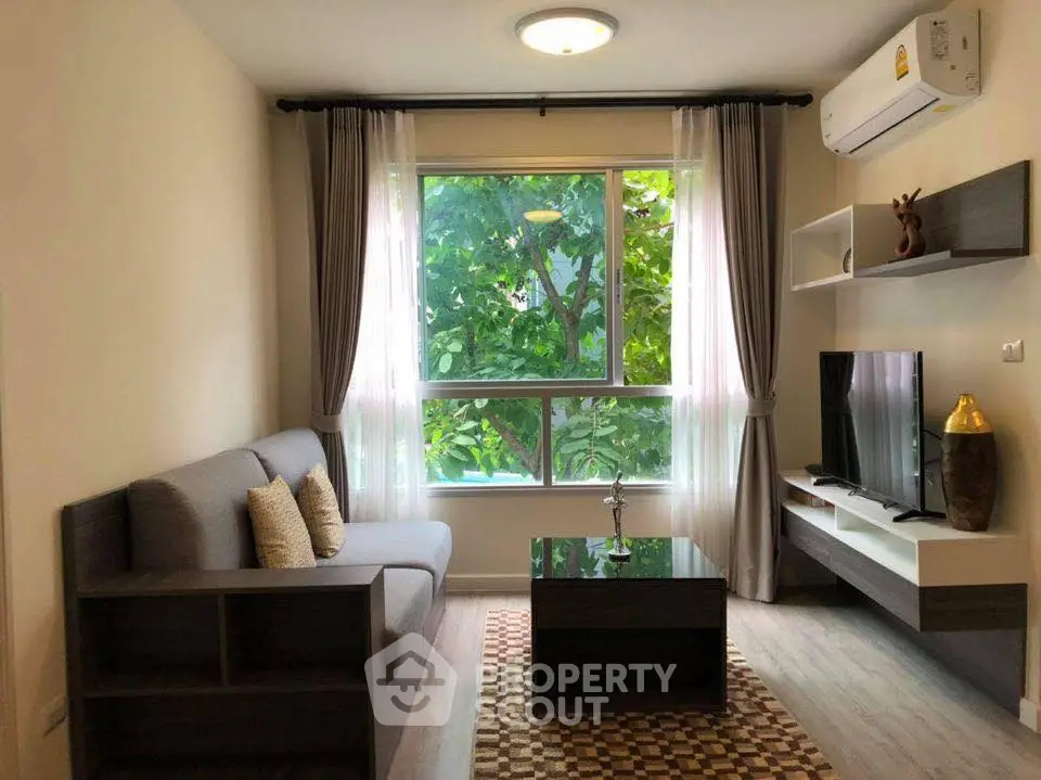Cozy living room with modern decor and large window view
