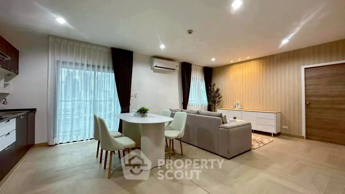 Modern open-plan living room with elegant dining area and stylish decor