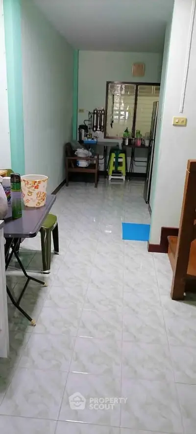Spacious kitchen with tiled flooring and open layout, featuring modern appliances and ample natural light.