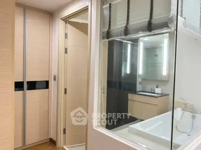 Modern bathroom with sleek design, featuring a bathtub and stylish lighting.