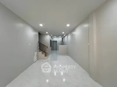 Spacious modern interior with sleek marble flooring and elegant staircase, perfect for contemporary living.