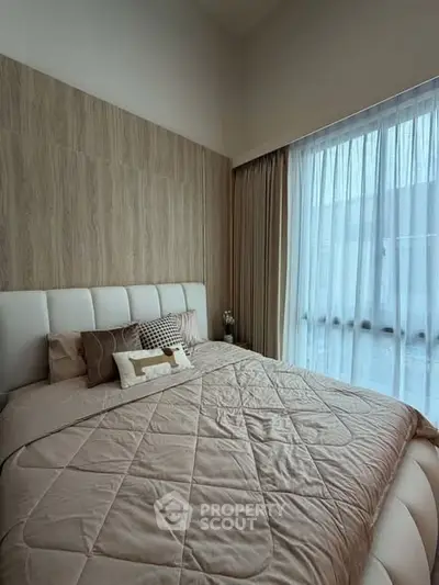 Cozy bedroom with elegant decor and large window for natural light