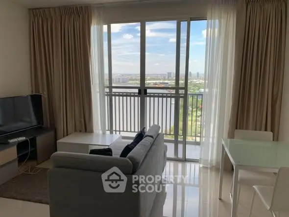 Modern living room with stunning balcony view and sleek furnishings.