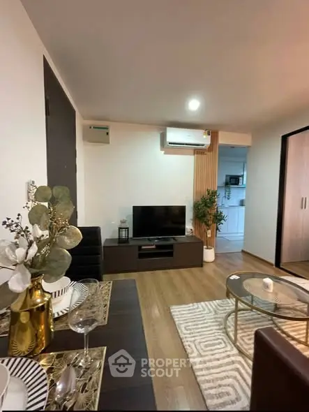 Modern living room with stylish decor and open layout, featuring a cozy dining area and sleek entertainment center.