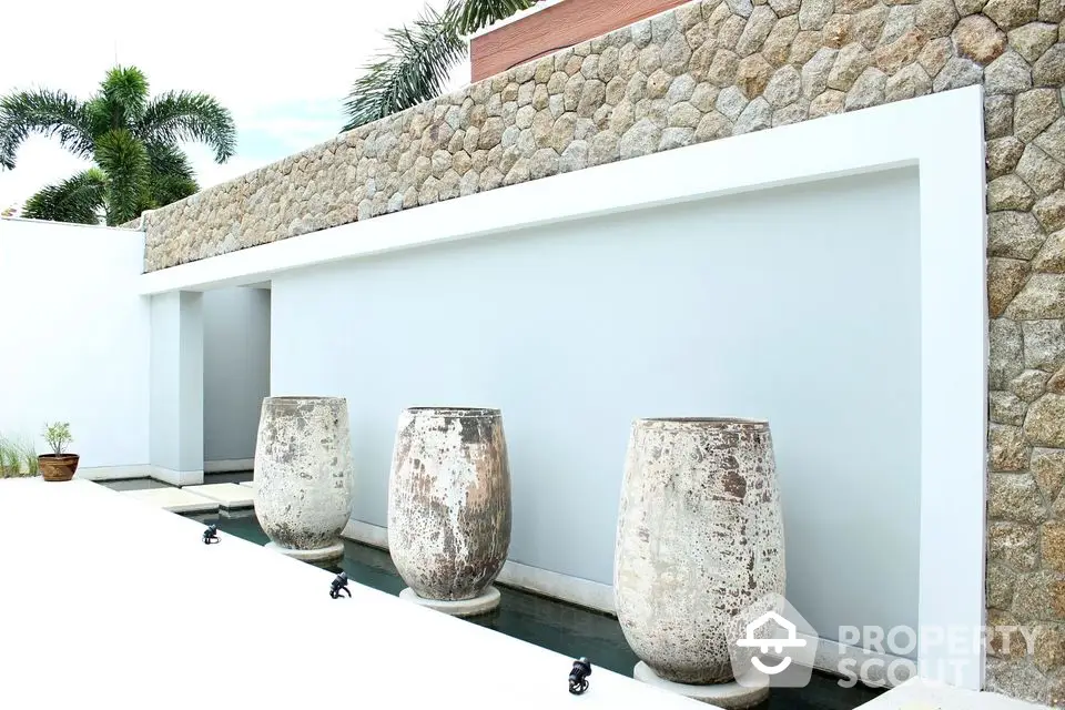 Elegant exterior with stone wall and decorative urns in modern design