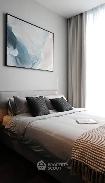 Modern bedroom with stylish decor and large window for natural light