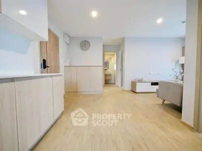 Spacious modern living room with wooden flooring and neutral decor