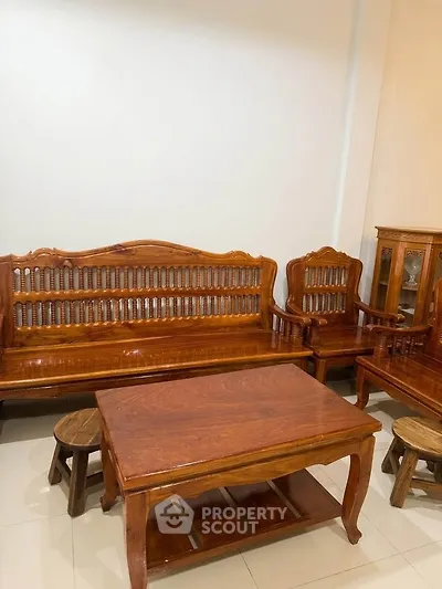 Elegant wooden furniture set in a cozy living room with polished flooring, perfect for a warm and inviting home ambiance.