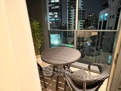 Chic urban balcony with night city view, perfect for relaxing evenings.