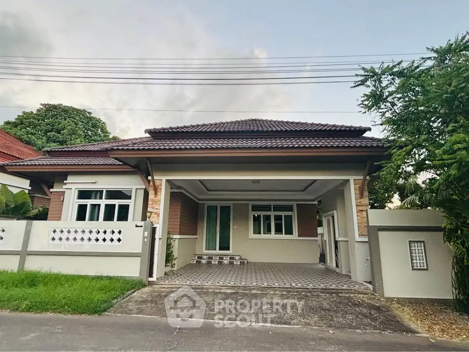 Charming single-story house with tiled roof and spacious driveway in a serene neighborhood.