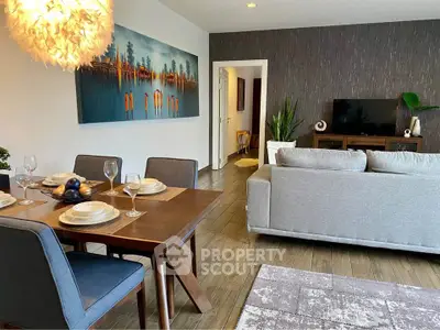 Stylish living room with modern decor and dining area, featuring elegant lighting and contemporary artwork.
