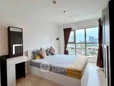 Modern bedroom with city view, featuring stylish decor and large windows for natural light.