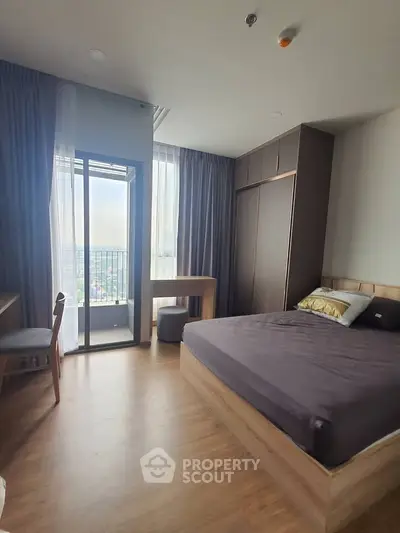 Modern bedroom with balcony view in high-rise apartment