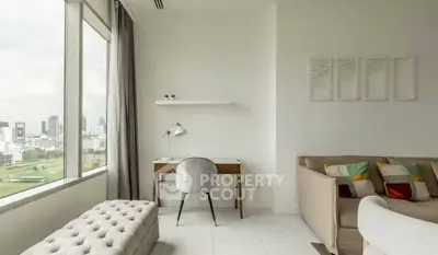 Modern living room with city view, featuring stylish furniture and natural light.