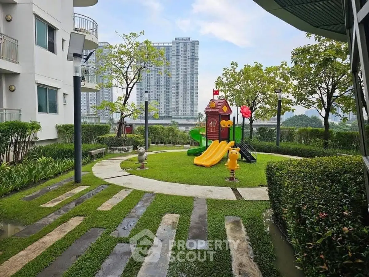 Modern residential playground with vibrant slides and lush greenery