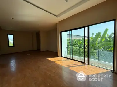 Spacious living room with large windows and garden view