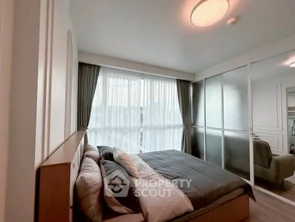 Modern bedroom with large window and stylish decor