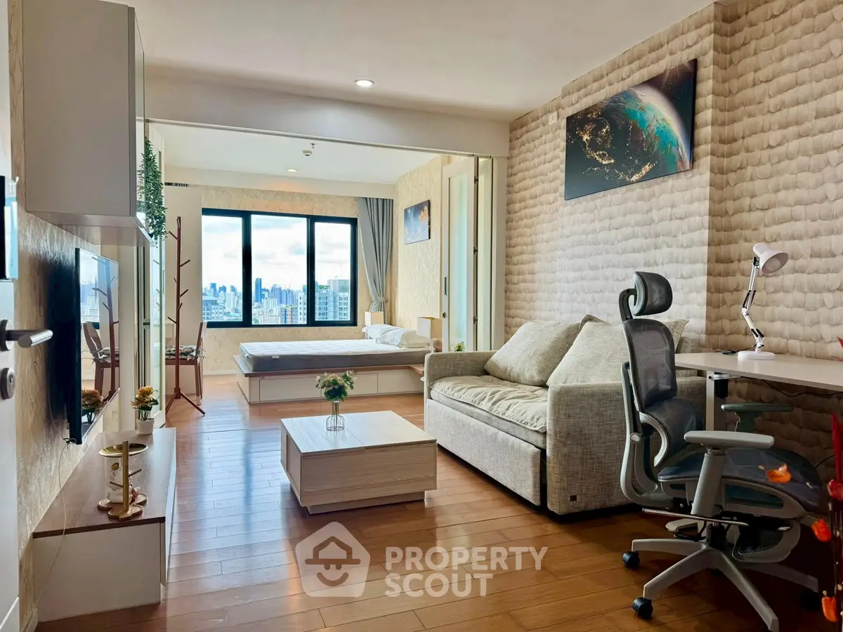 Modern open-plan living room with city view, featuring stylish furniture and wooden flooring.