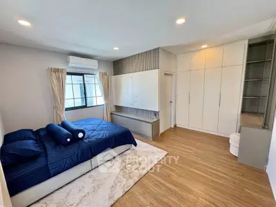 Spacious modern bedroom with elegant decor and ample storage space