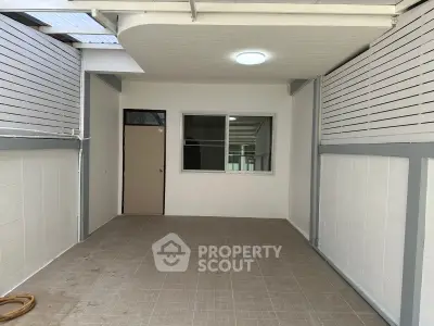 Spacious covered patio with tiled flooring and modern design, perfect for outdoor relaxation or entertainment.