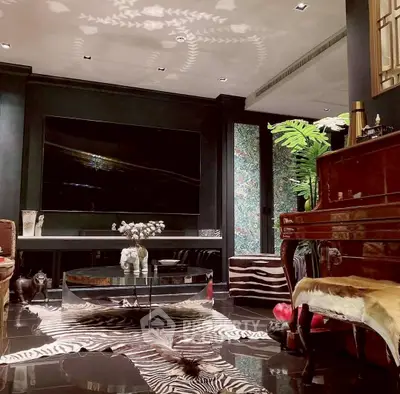 Luxurious living room with elegant decor, large TV, and stylish furniture in a modern home.