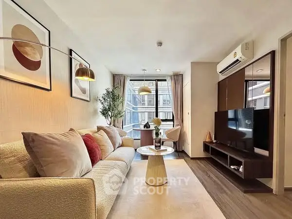 Modern living room with cozy sofa, stylish decor, and natural light.