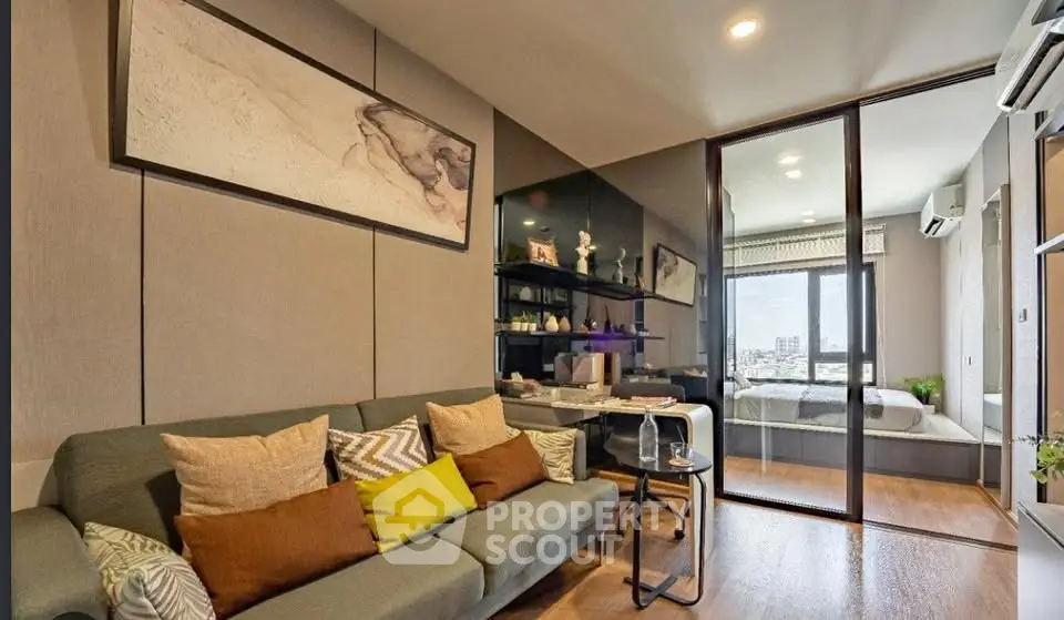 Modern living room with stylish decor and view into cozy bedroom