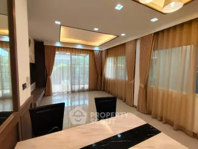 Spacious living room with elegant curtains and modern lighting