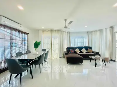 Spacious modern living room with elegant dining area and natural light
