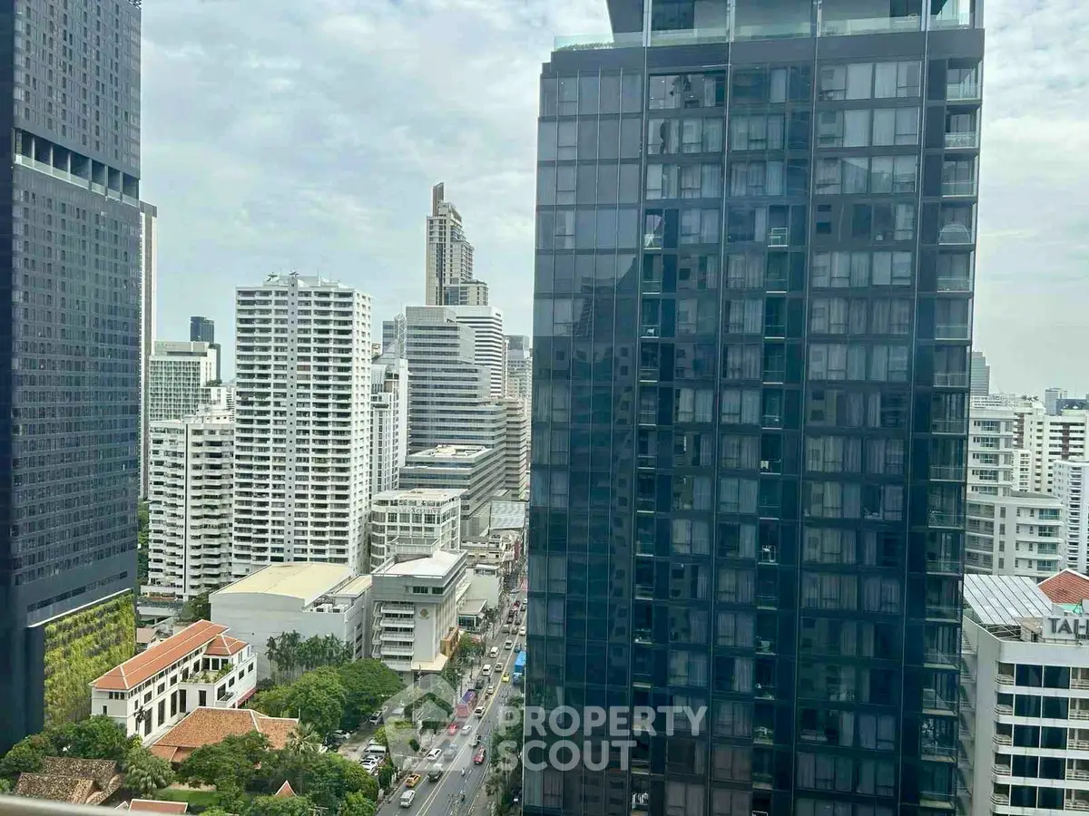 Stunning cityscape view from a high-rise building showcasing modern architecture and vibrant urban life.