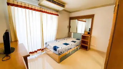 Bright and cozy bedroom with modern furnishings and large window for natural light.