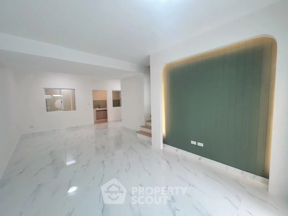 Spacious modern living room with elegant marble flooring and stylish accent wall