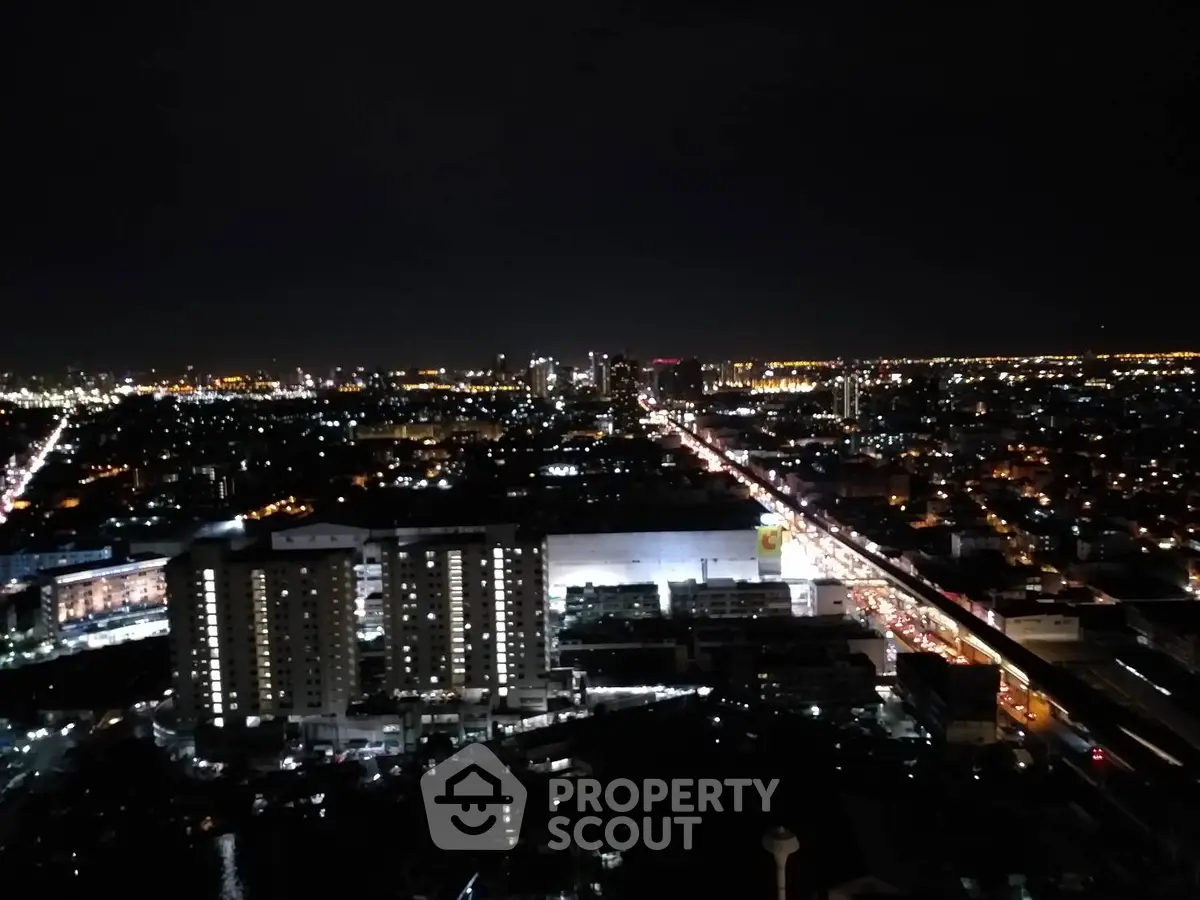 Stunning cityscape night view from high-rise building showcasing vibrant urban lights.