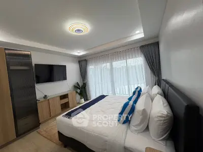 Modern bedroom with stylish decor and natural light from large windows.